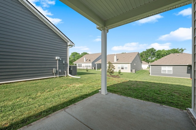 view of yard featuring a patio, central AC, and a residential view