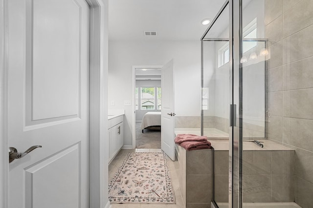 ensuite bathroom featuring vanity, visible vents, ensuite bathroom, tile patterned floors, and a shower stall