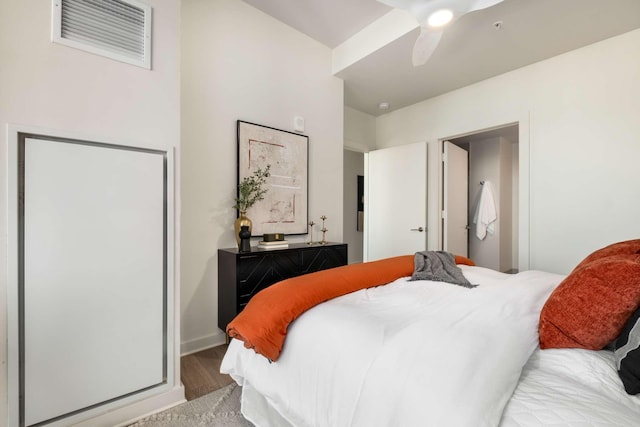 bedroom featuring visible vents, a ceiling fan, baseboards, and wood finished floors