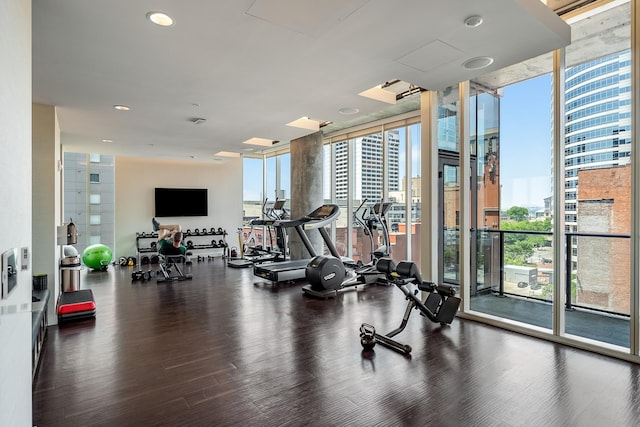 gym featuring recessed lighting, expansive windows, and wood finished floors