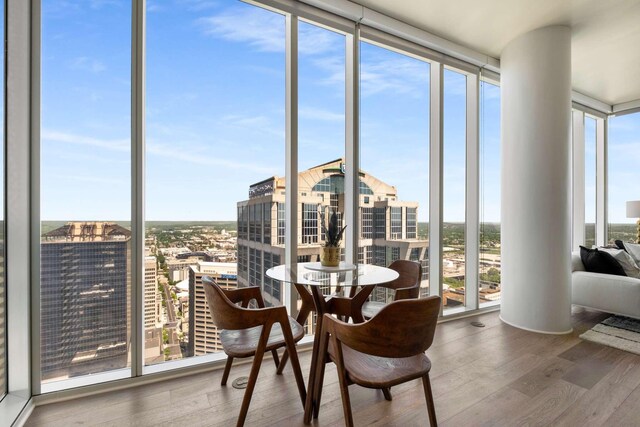 sunroom / solarium with a healthy amount of sunlight and a view of city