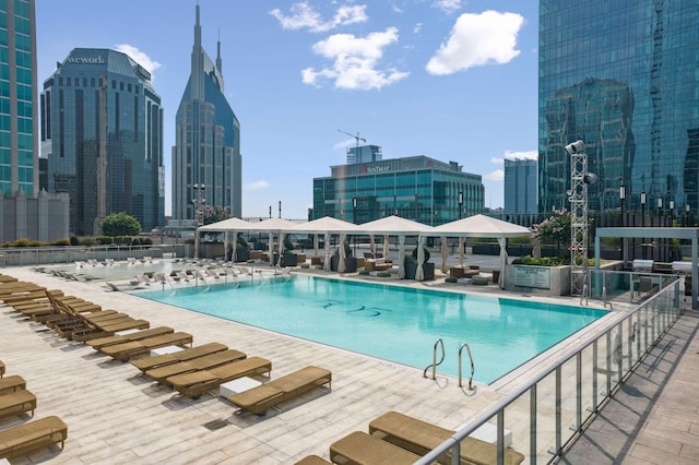 community pool featuring a view of city, a gazebo, and a patio area