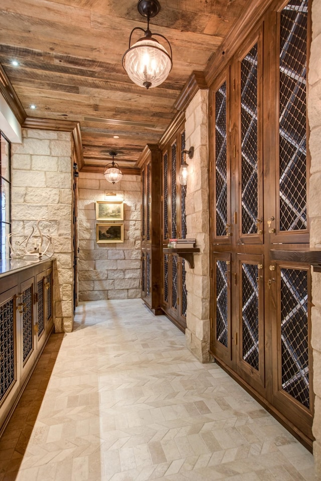 wine area featuring wooden ceiling and ornamental molding