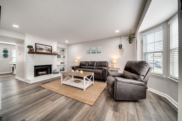 250 Sanders Ferry Rd Unit 4, Hendersonville, TN 37075 - living area featuring a brick fireplace, baseboards, a healthy amount of sunlight, and wood finished floors
