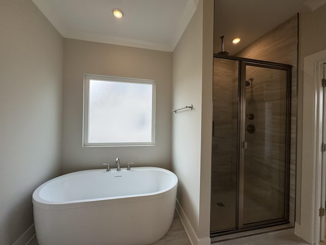 full bathroom with recessed lighting, baseboards, a freestanding tub, and a stall shower