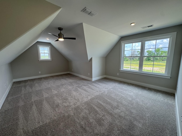 bonus room featuring baseboards, visible vents, and lofted ceiling