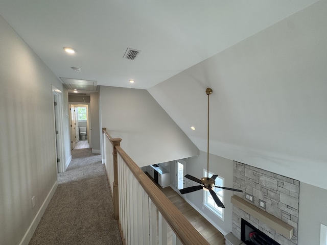 corridor featuring carpet flooring, attic access, baseboards, an upstairs landing, and visible vents