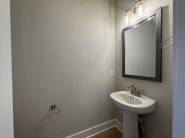 bathroom featuring baseboards and wood finished floors
