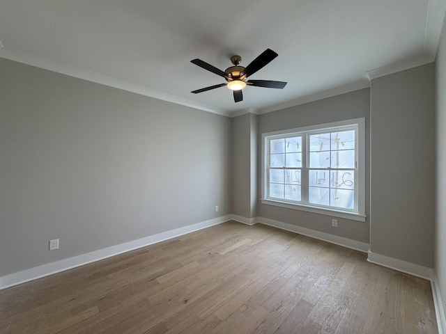 unfurnished room featuring crown molding, a ceiling fan, light wood finished floors, and baseboards