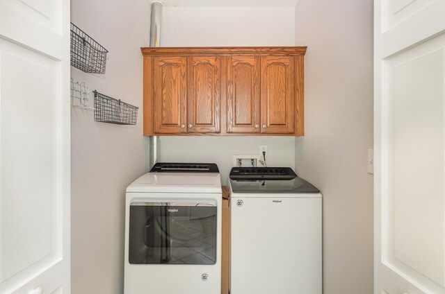 washroom featuring cabinet space and washing machine and dryer