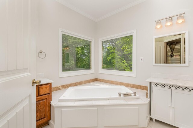 bathroom with crown molding, a garden tub, and vanity