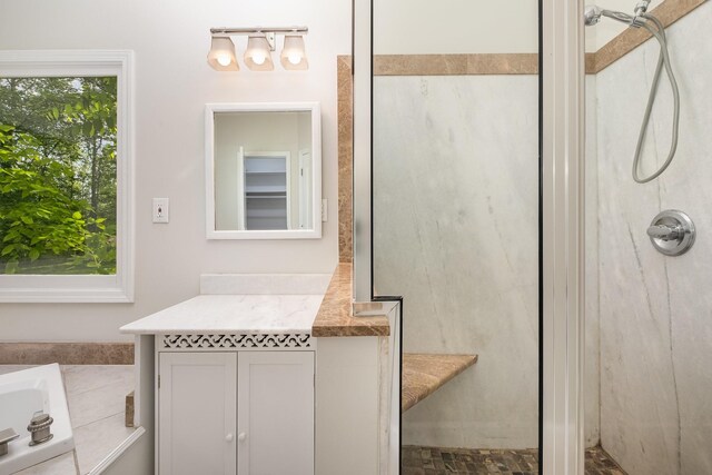 full bathroom featuring walk in shower, a garden tub, and vanity
