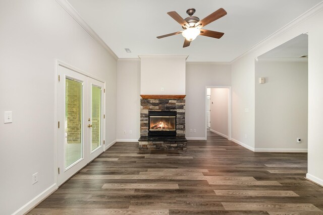 living room with ornamental molding, wood finished floors, a fireplace, baseboards, and a ceiling fan