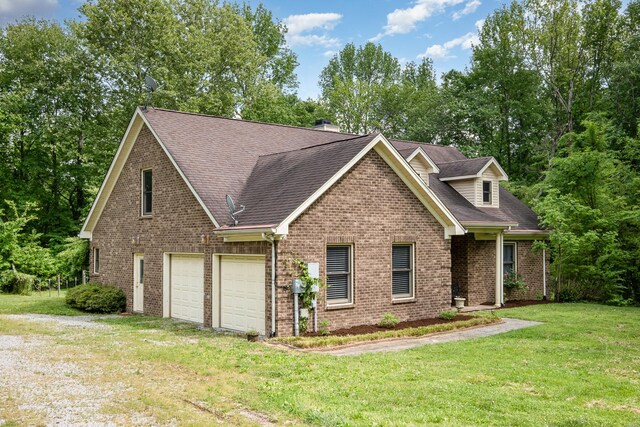 craftsman house with brick siding, a front lawn, roof with shingles, and a garage