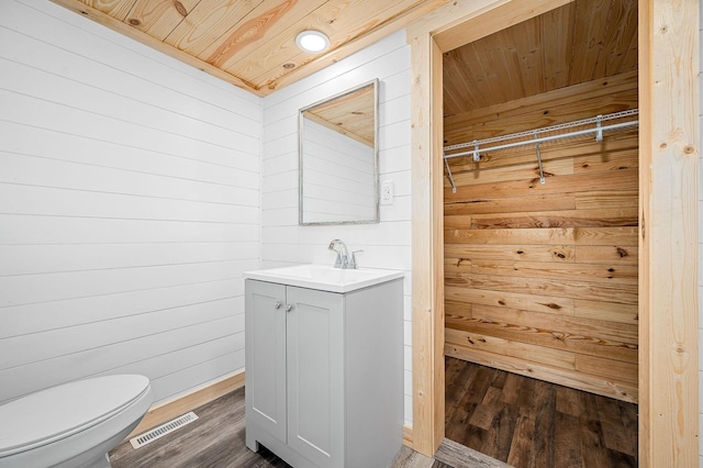 200 Tucker St, Decherd, TN 37324 - bathroom with wood walls, wooden ceiling, vanity, toilet, and wood finished floors