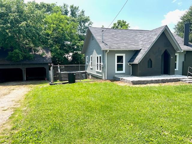 200 Tucker St, Decherd, TN 37324 - back of house featuring a yard and a chimney