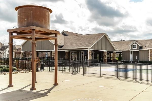 community pool featuring fence and a patio area