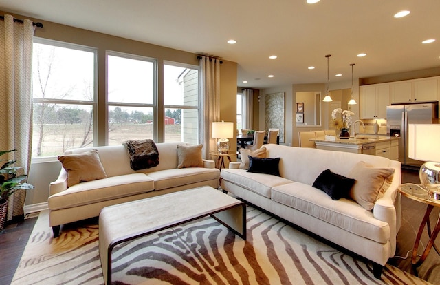 living room with recessed lighting, wood finished floors, and a wealth of natural light