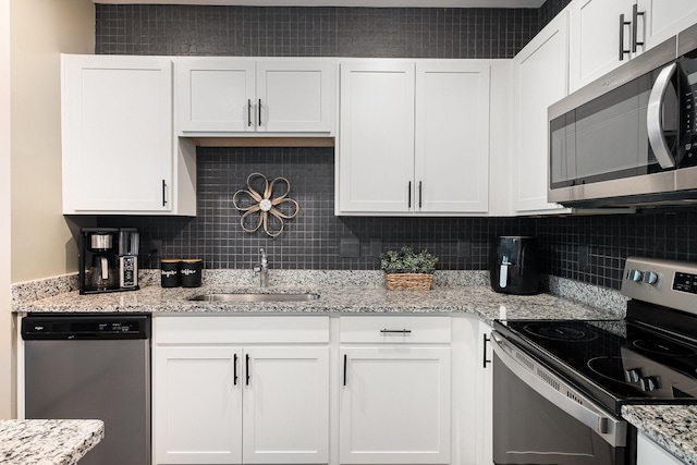 156 Cecil Rd, Lebanon, TN 37087 - kitchen with appliances with stainless steel finishes, a sink, white cabinetry, and tasteful backsplash