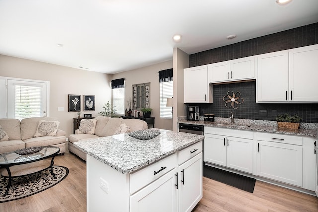 156 Cecil Rd, Lebanon, TN 37087 - kitchen with a sink, a kitchen island, light wood-type flooring, light stone counters, and recessed lighting