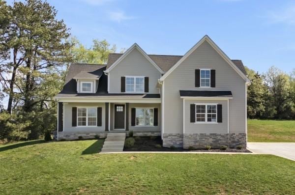 view of front of property with stone siding and a front yard
