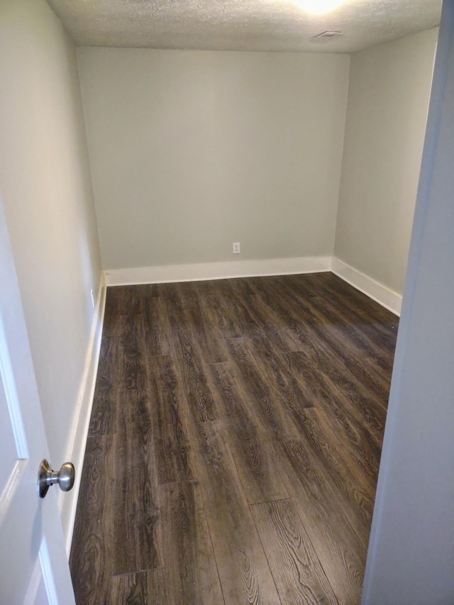 121 Swann St, Mcminnville, TN 37110 - empty room with baseboards, a textured ceiling, and dark wood-style floors