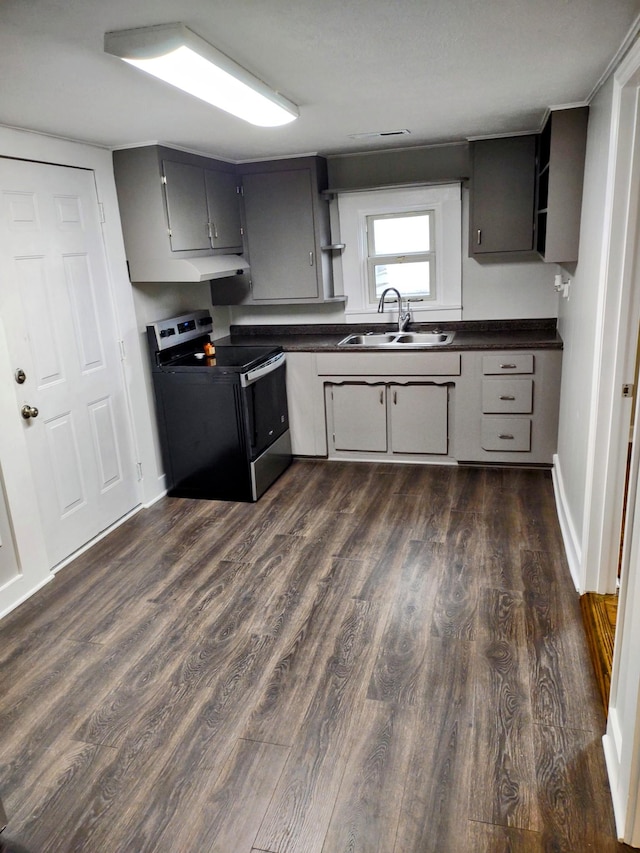121 Swann St, Mcminnville, TN 37110 - kitchen with dark countertops, a sink, dark wood-style floors, and range with electric stovetop