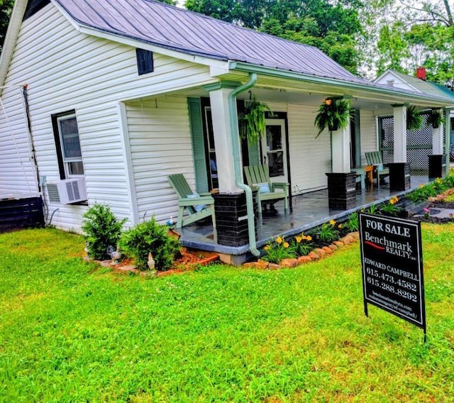 121 Swann St, Mcminnville, TN 37110 - rear view of house featuring a porch, a yard, and metal roof
