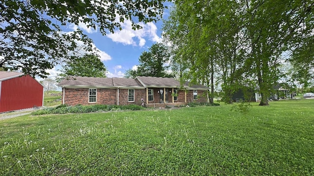ranch-style house featuring brick siding and a front yard