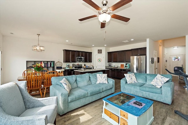 living room with recessed lighting, a ceiling fan, and light wood finished floors