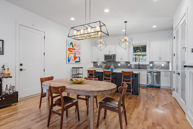 1811 Meridian St, Nashville, TN 37207 - dining space with light wood-style floors, recessed lighting, and an inviting chandelier