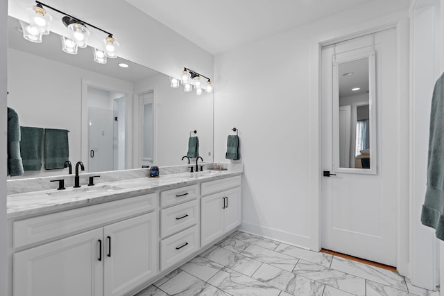 1811 Meridian St, Nashville, TN 37207 - full bathroom featuring double vanity, a sink, marble finish floor, and baseboards