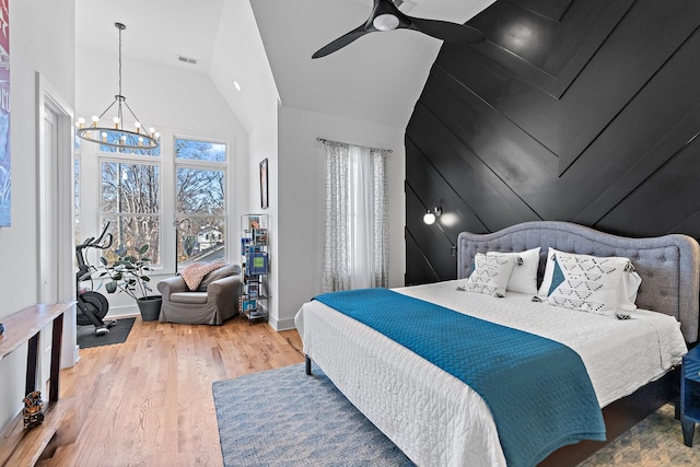 1811 Meridian St, Nashville, TN 37207 - bedroom with visible vents, ceiling fan with notable chandelier, wood finished floors, and high vaulted ceiling