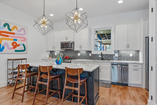 1811 Meridian St, Nashville, TN 37207 - kitchen featuring a sink, appliances with stainless steel finishes, white cabinets, and tasteful backsplash