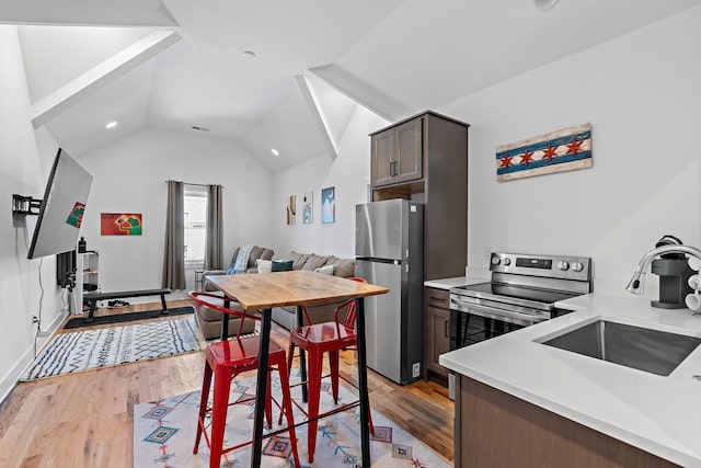 1811 Meridian St, Nashville, TN 37207 - kitchen featuring a sink, light countertops, stainless steel appliances, light wood-type flooring, and vaulted ceiling