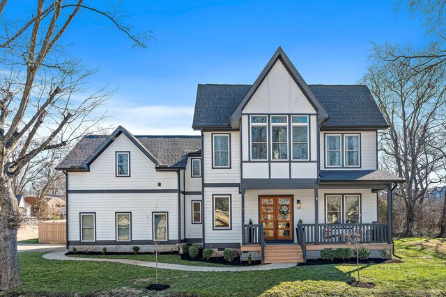 1811 Meridian St, Nashville, TN 37207 - modern inspired farmhouse with covered porch, roof with shingles, and a front lawn