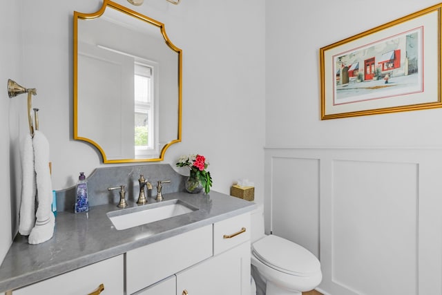 half bath featuring toilet and vanity