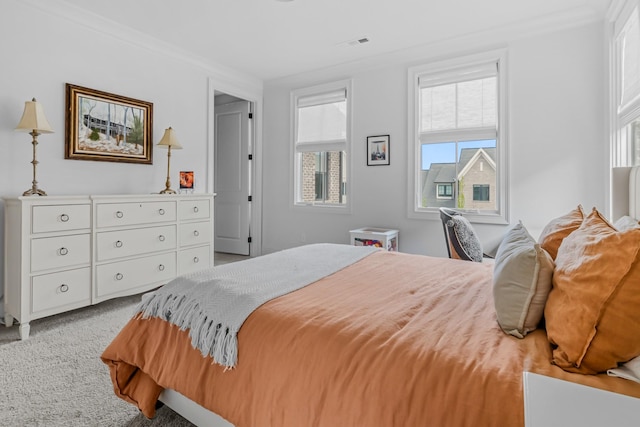 bedroom featuring crown molding, carpet floors, and visible vents