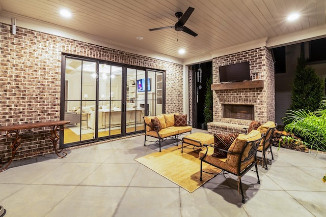 view of patio with ceiling fan and an outdoor living space with a fireplace