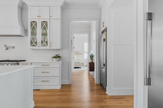 hall featuring ornamental molding and light wood-style flooring