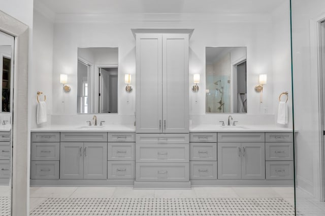 full bathroom with tile patterned flooring, ornamental molding, a shower with shower door, and vanity
