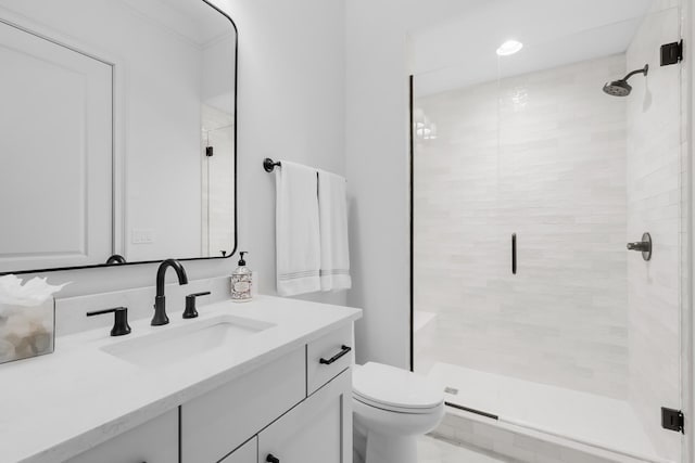 bathroom featuring vanity, a stall shower, and toilet