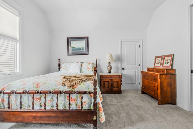 bedroom featuring carpet floors and vaulted ceiling
