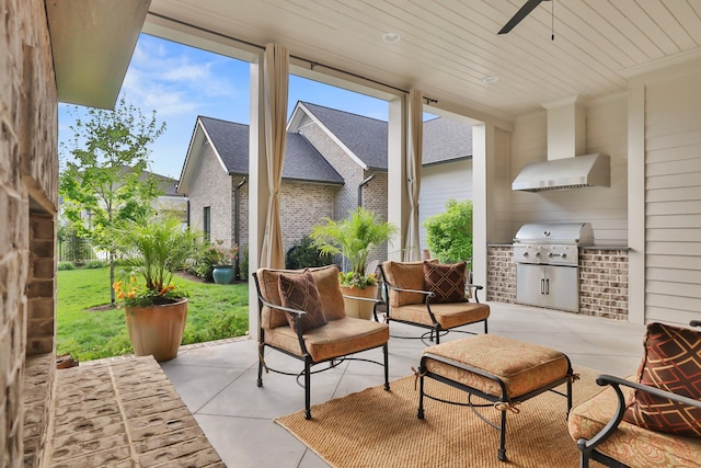 view of patio / terrace with area for grilling, ceiling fan, and a grill
