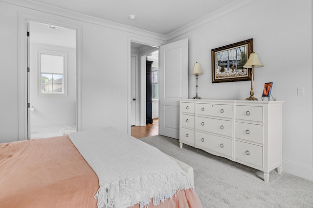bedroom featuring crown molding, baseboards, light carpet, and multiple windows