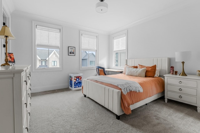 bedroom featuring baseboards, ornamental molding, and carpet