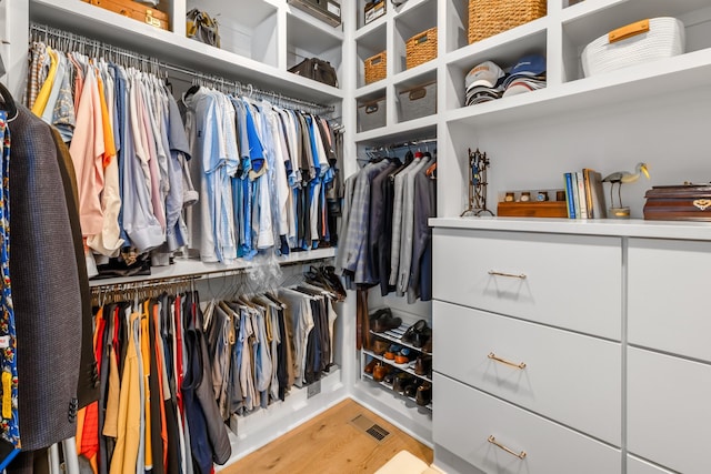 walk in closet with visible vents and wood finished floors