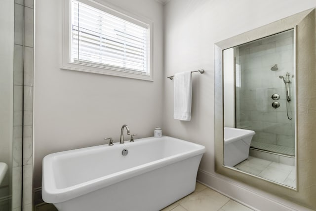 full bathroom with marble finish floor, a freestanding tub, and a shower stall