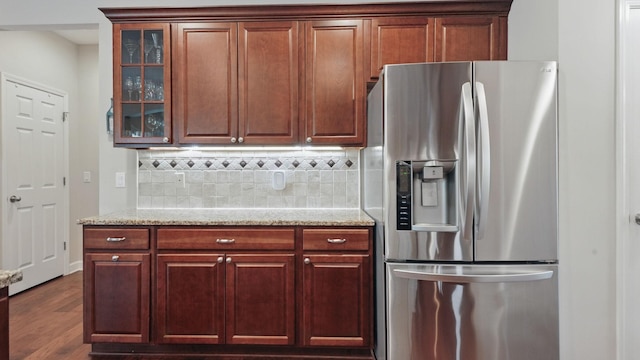 1011 Gatewick Ct, Franklin, TN 37067 - kitchen featuring stainless steel refrigerator with ice dispenser, decorative backsplash, glass insert cabinets, and light stone countertops