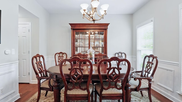 1011 Gatewick Ct, Franklin, TN 37067 - dining area with a chandelier, a wainscoted wall, dark wood-type flooring, and a decorative wall